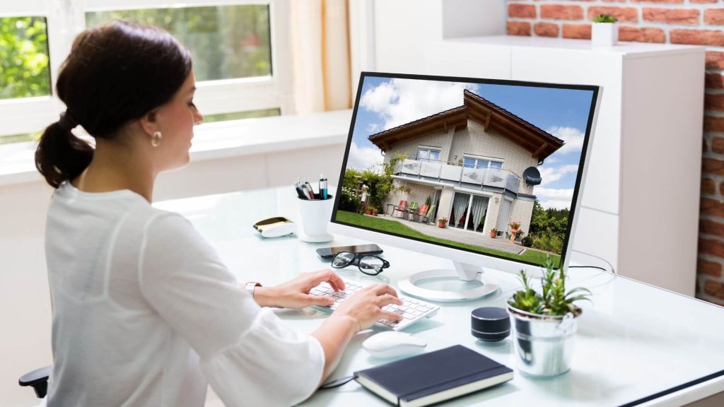 Real life property investors researching real estate opportunities on a computer, showcasing a potential investment property. The image represents the process of exploring real estate investments and making informed decisions in property investment.